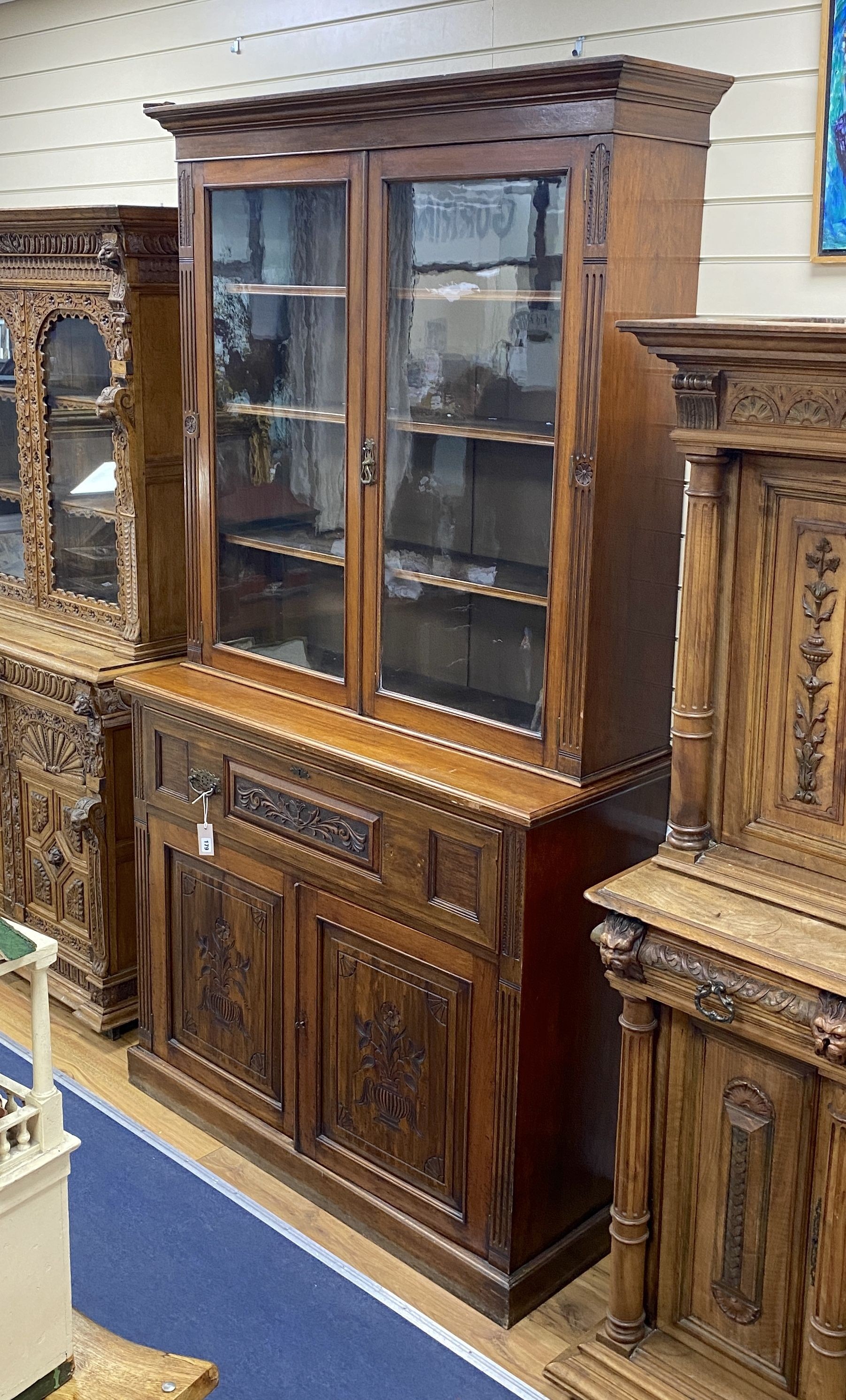 A late Victorian carved walnut secretaire bookcase, length 122cm, depth 48cm, height 226cm
